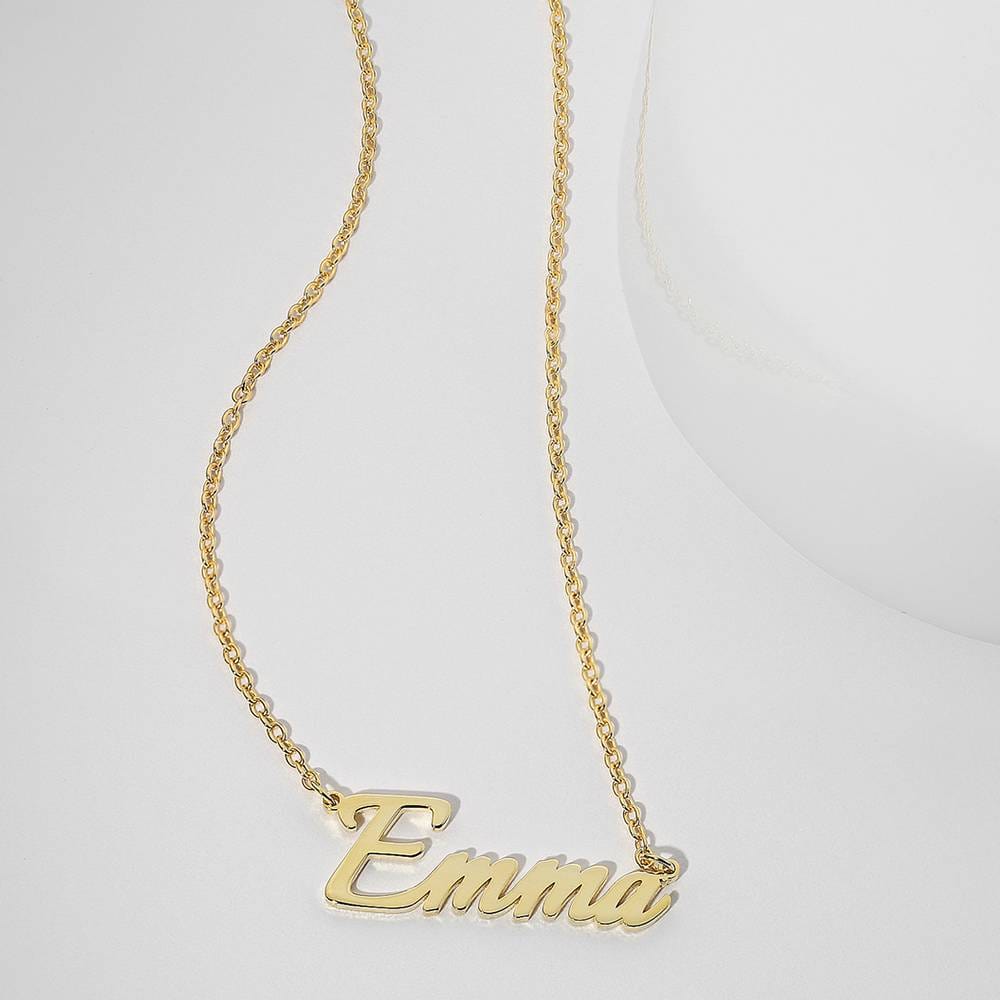 Gold-tone Emma name pendant displayed on a pale surface