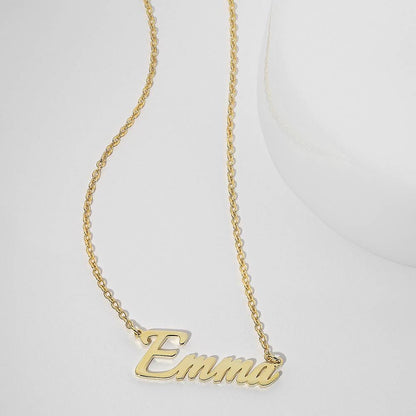 Gold-tone Emma name pendant displayed on a pale surface