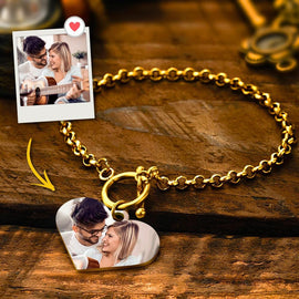 Gold-tone chain bracelet with a heart photo charm beside the source couple photograph