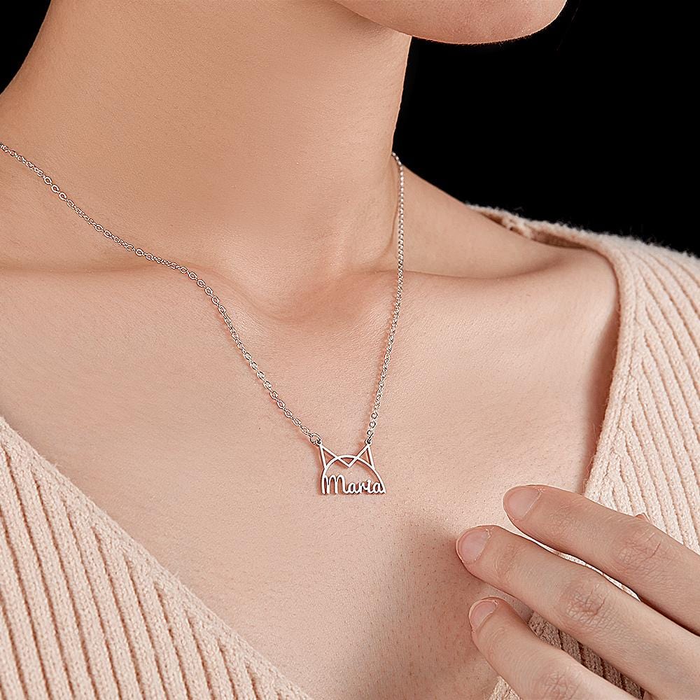 Model wearing a silver-tone cat-ear name necklace