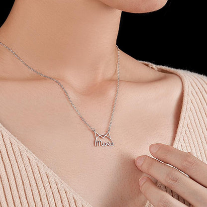 Model wearing a silver-tone cat-ear name necklace