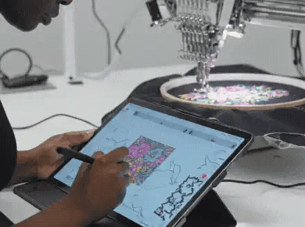 Computerized embroidery machine stitching a custom floral design